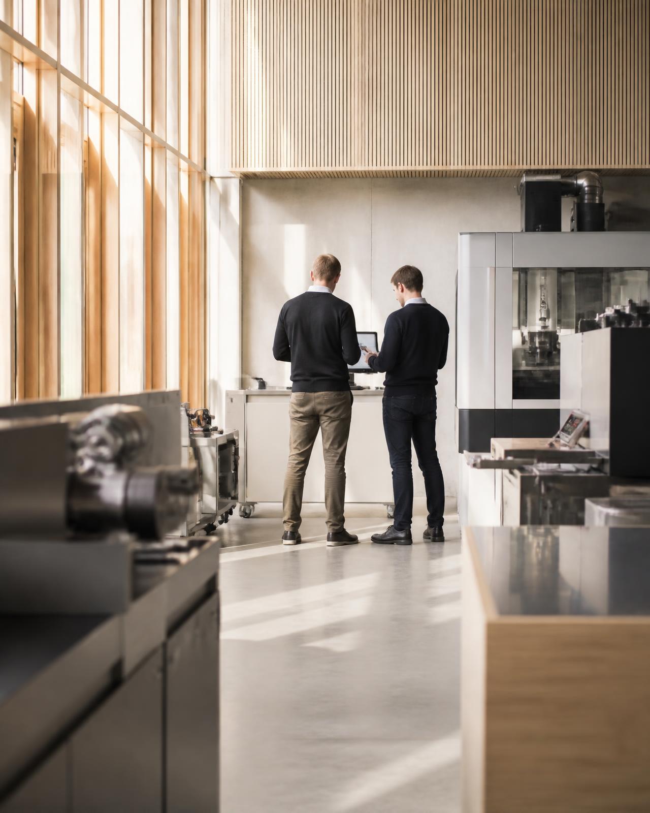 Modern Nordic industrial facility with professionals collaborating in natural light